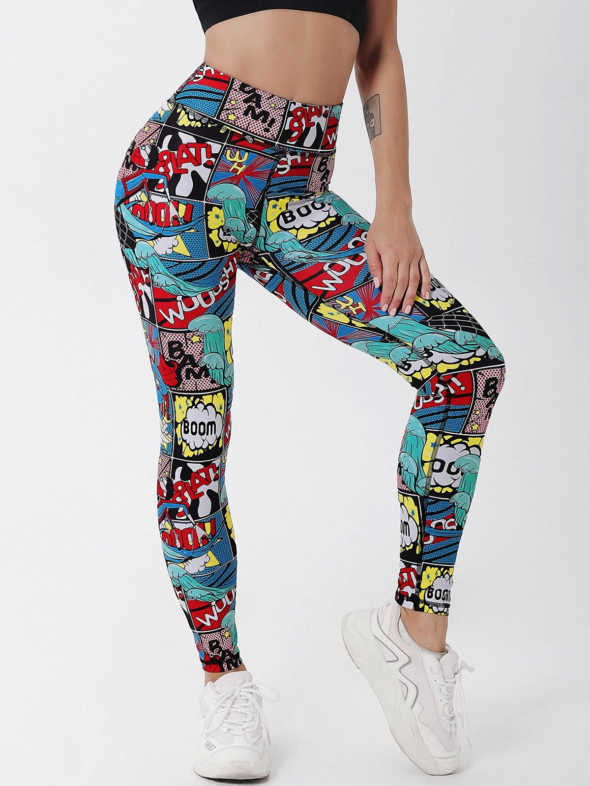 Colorful graphic leggings worn by a person on a white background