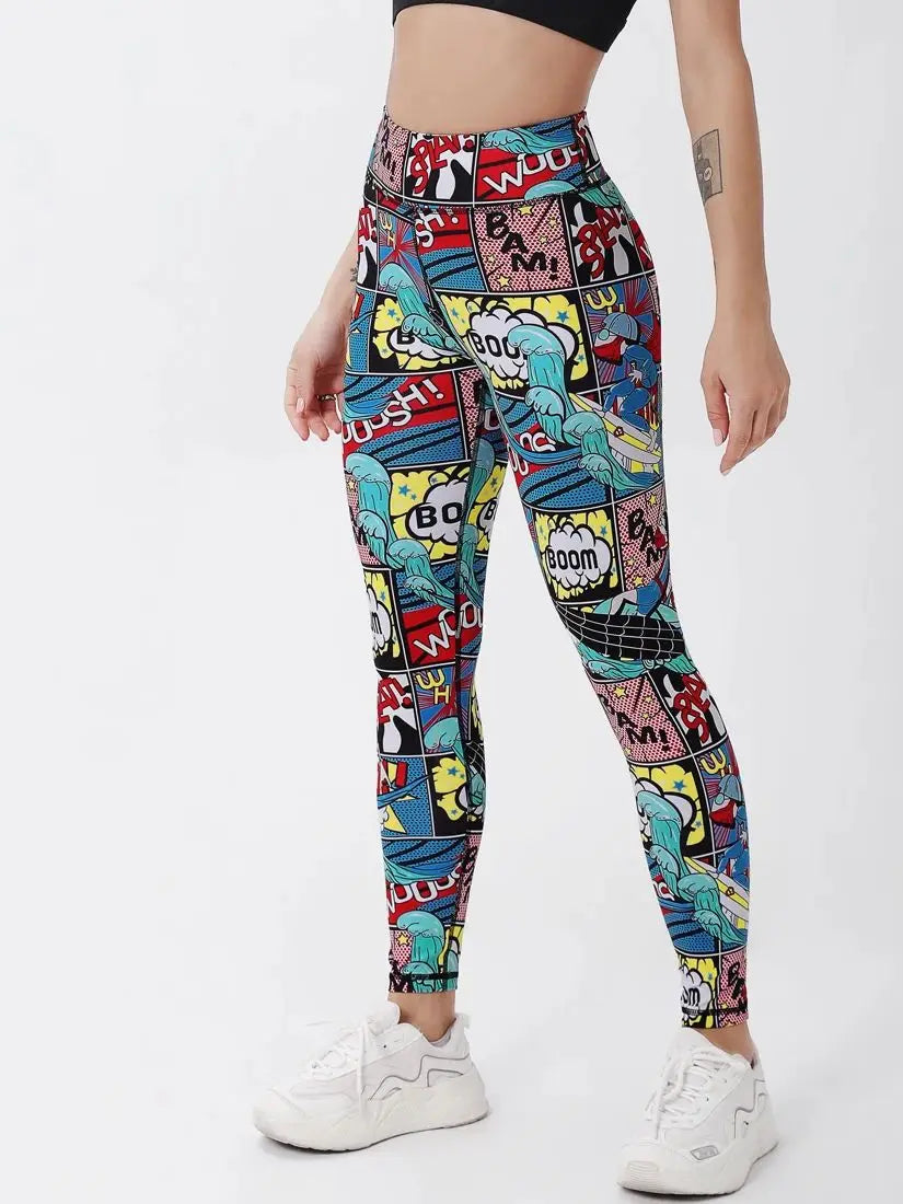 A model wearing high-waisted leggings with a colorful comic book pop-art print, paired with white sneakers, shown from the waist down against a plain white background.